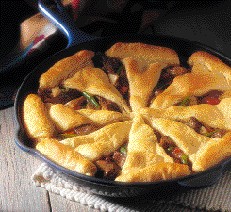 This beef pot pie is topped with buttery crescents