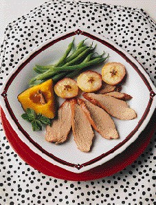 New England pork tenderloin served with green beans and baked apple slices